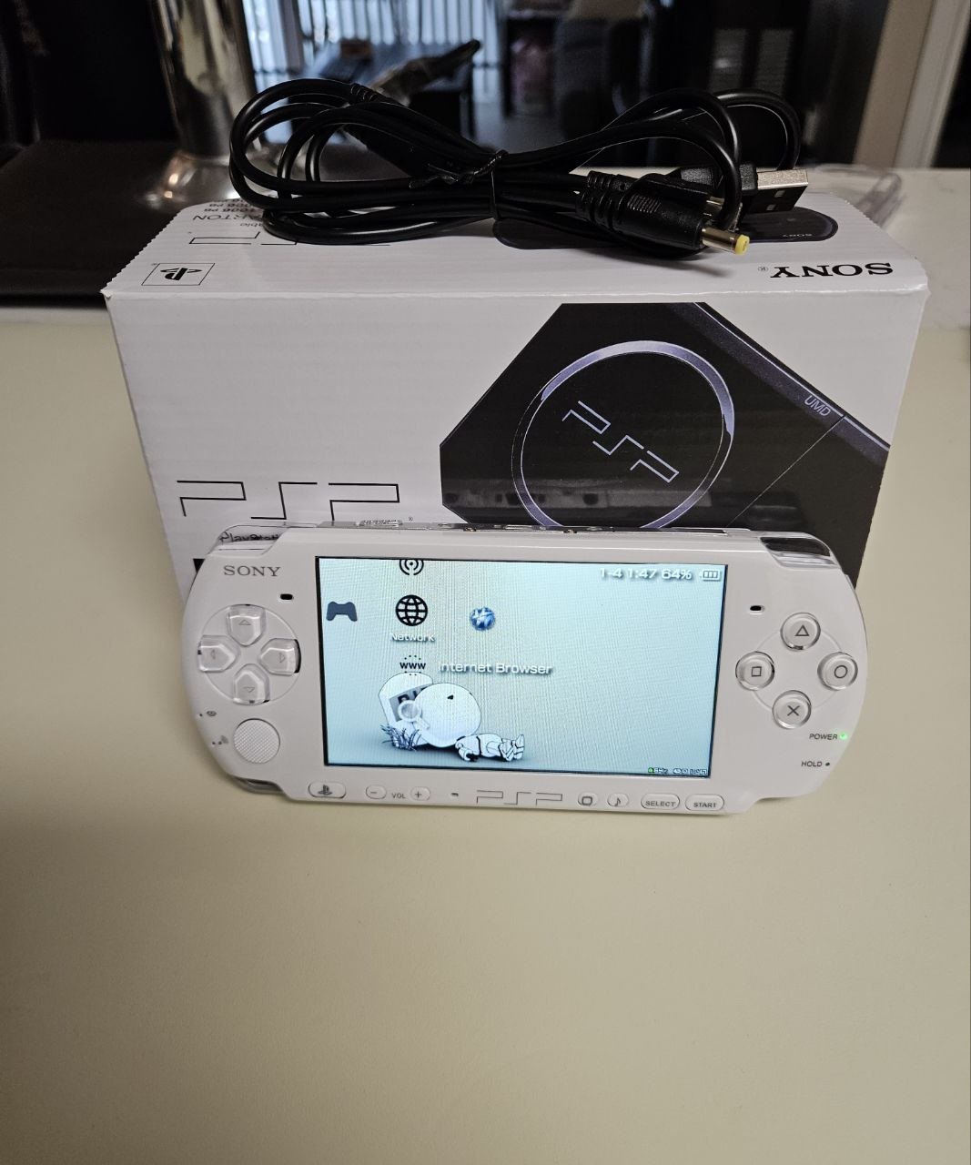 Arctic Pearl PSP-3000 powered on, pearl white finish