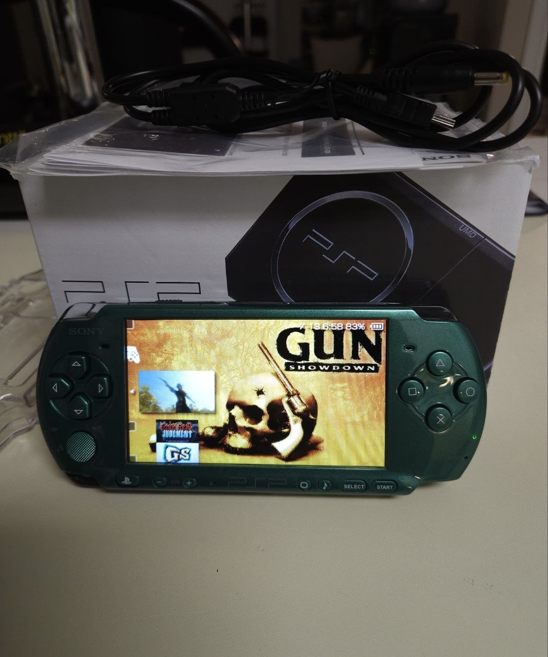 Emerald Phantom PSP-3000 powered on, metallic green finish