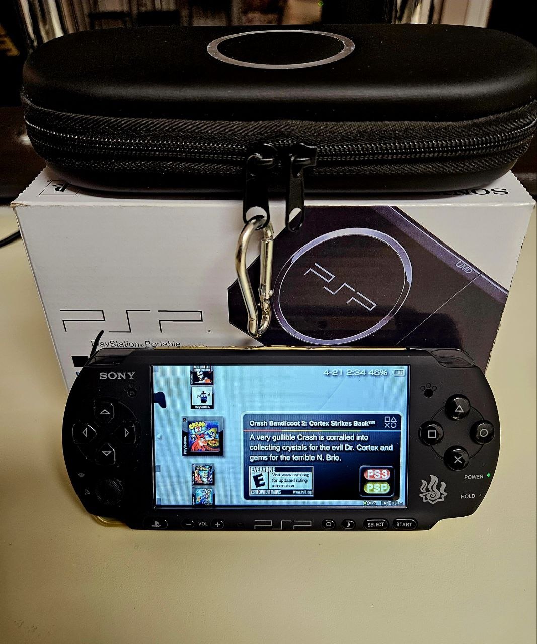 Monster Hunter Gold PSP-3000 powered on, gold trim and emblem