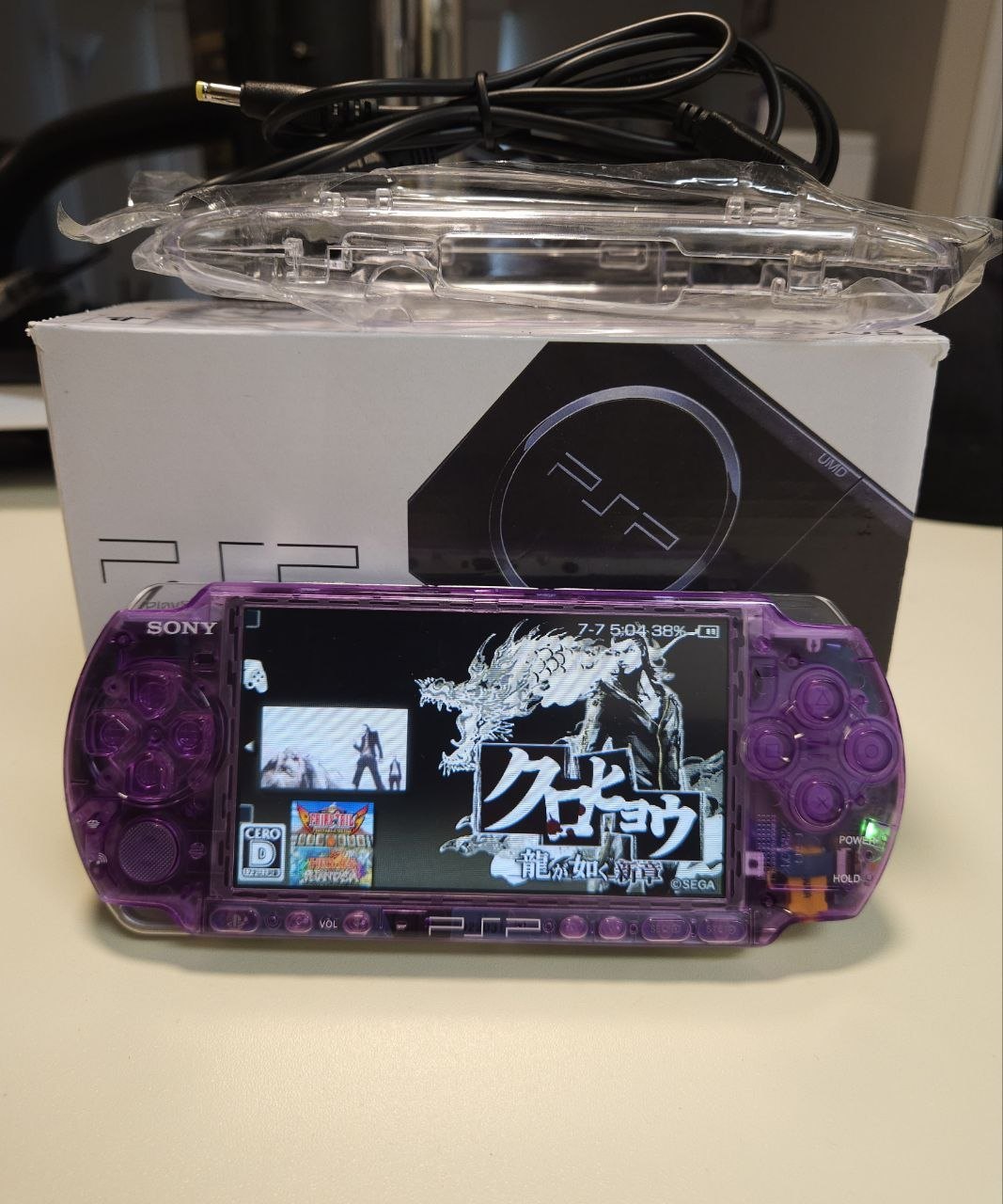Stealth Purple clear-shell PSP-3000 powered on