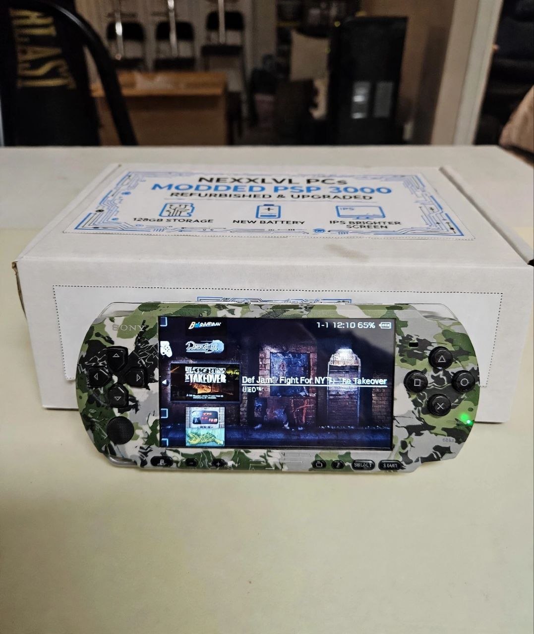 Tactical Camo PSP-3000 powered on, shown with NexxLvl PCs branded box